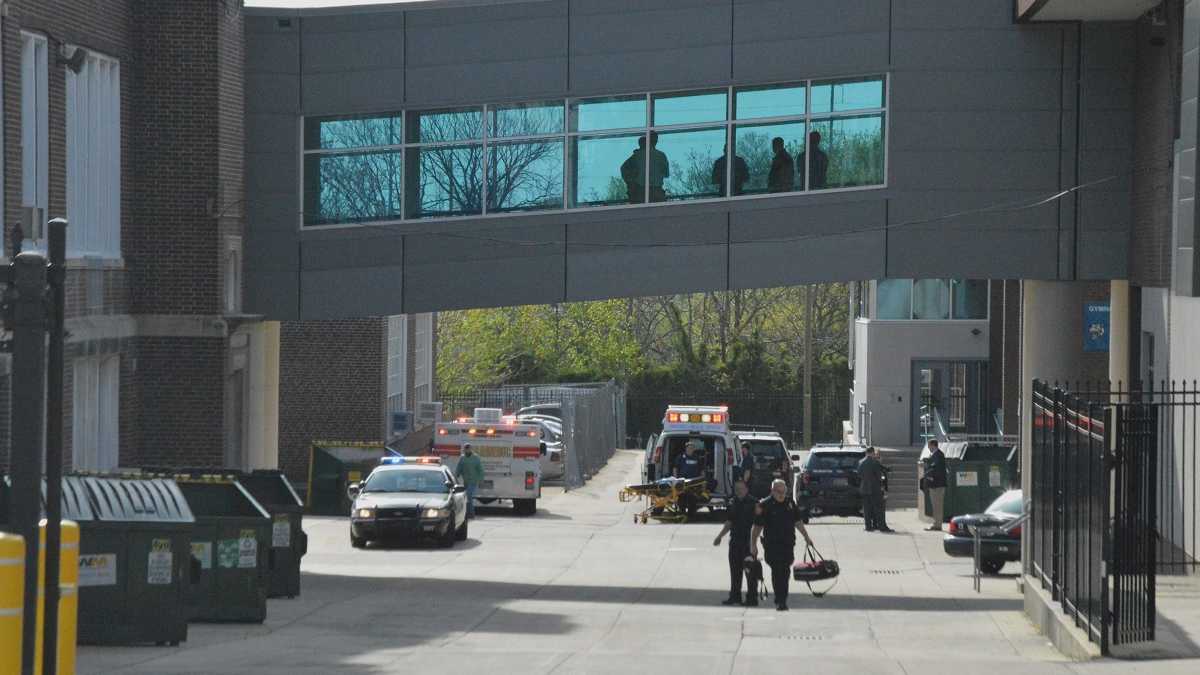 Paramedics walk outside Howard High School after a student was killed inside on April 21st. (File/WHYY)
