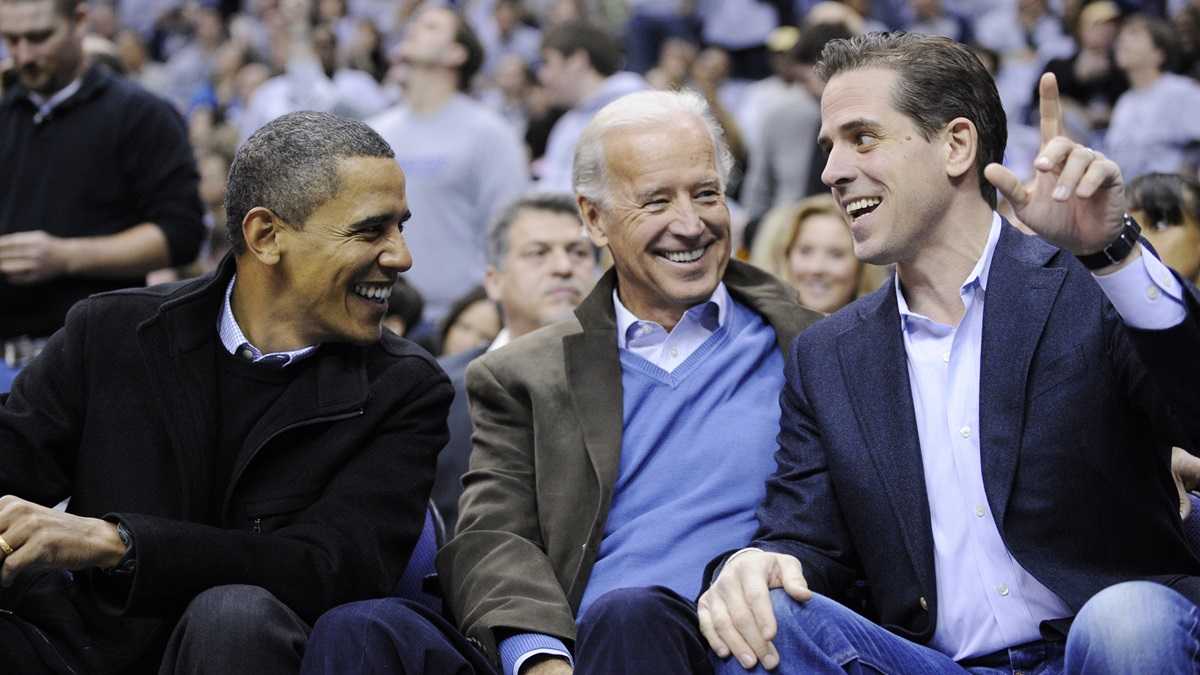 President Barack Obama talks with Vice President Joe Biden and his son Hunter Biden at the Duke Georgetown NCAA college basketball game