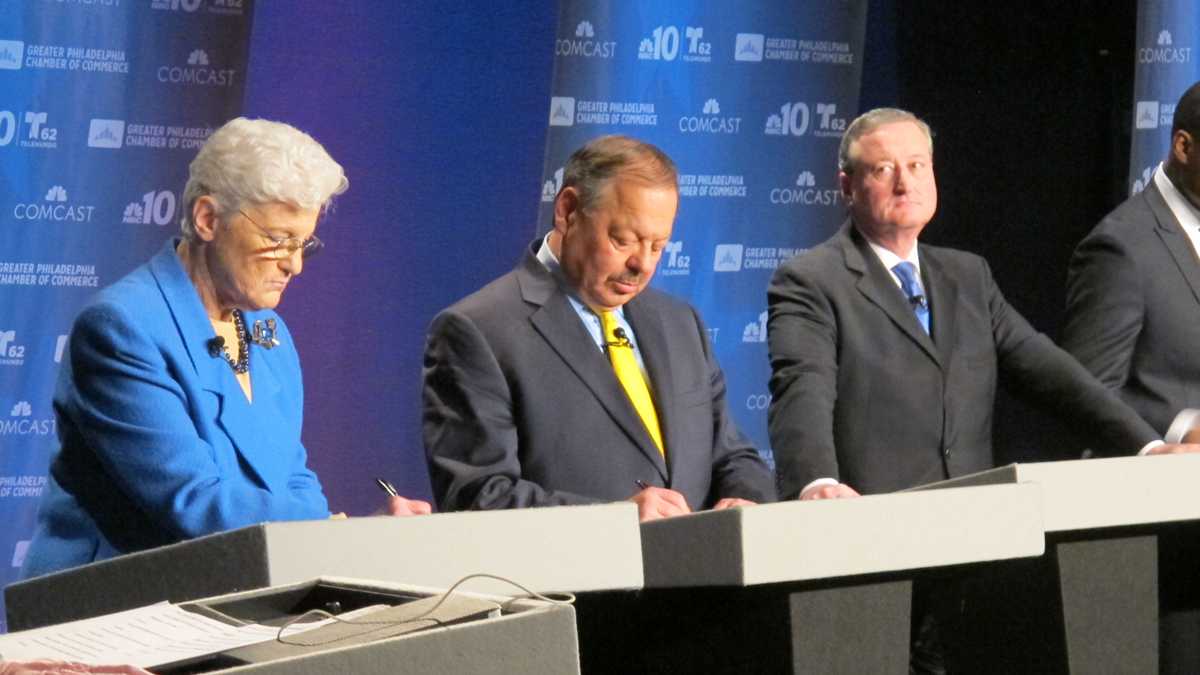  Mayoral candidate Lynne Abraham takes notes Tuesday night during a debate aired live on NBC10. Minutes later, she collapsed on the stage. (Katie Colaneri/WHYY)  