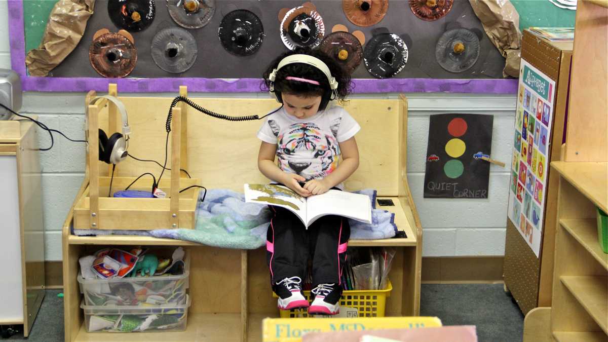  Kylee Mendez reads while she listens in her 4-year-old class at FELS Paley Center in North Philadelphia in this March, 2015, file photo. (Emma Lee/WHYY) 