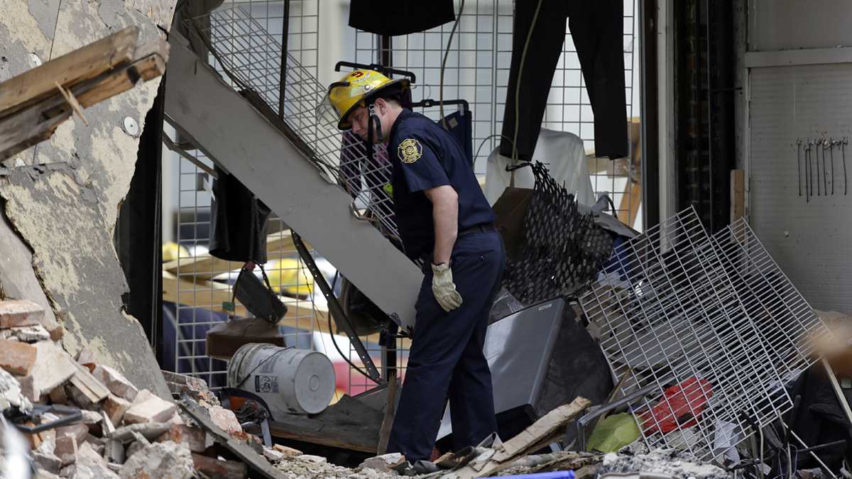 A firefighter walks through the aftermath of a building that collapsed in Center City