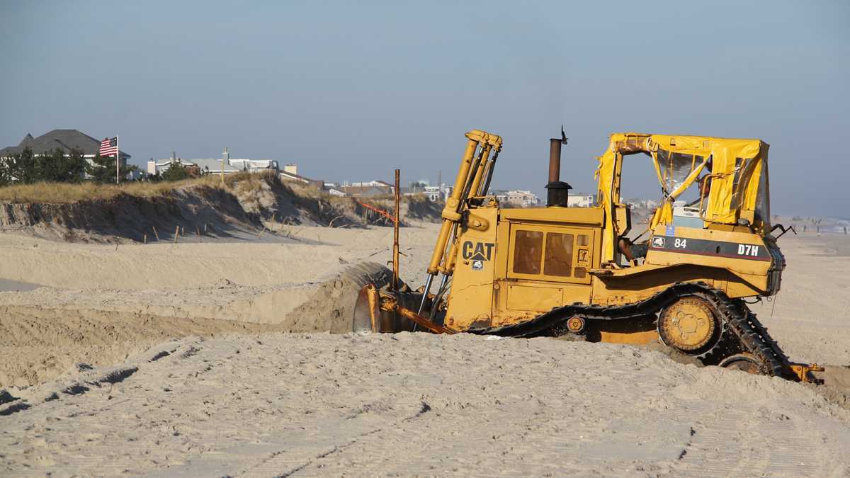  A bulldozer on Long Beach Island moves sand to restore the dunes that were swept away by Hurricane Sandy. (Emma Lee/for NewsWorks, file) 