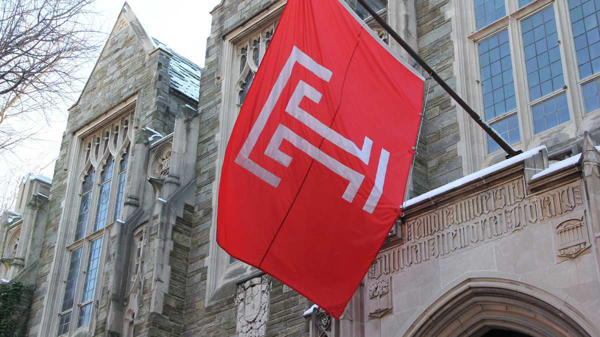  A Temple flag hangs above Sullivan Hall on the Temple University campus. (Emma Lee/WHYY)  