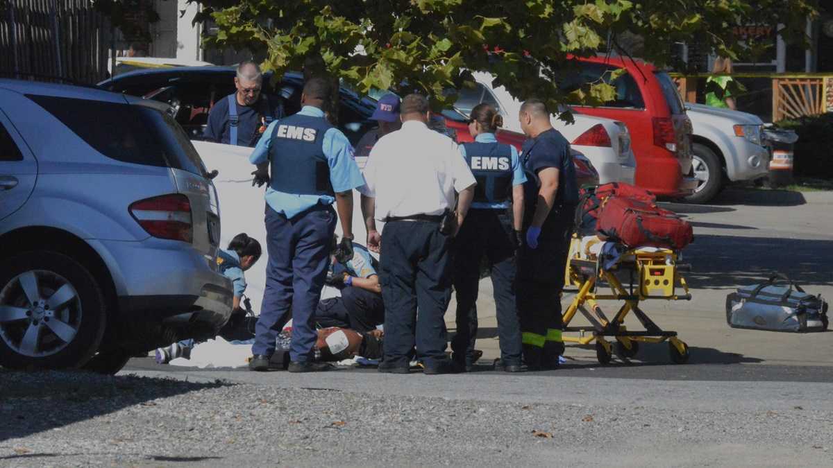 Paramedics work on Jeremy McDole after the wheelchair bound man was shot by Wilmington Police last year. (File/NewsWorks)