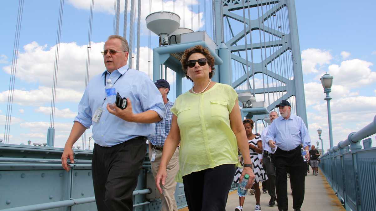  NJ Transit Executive Director Ronnie Hakim (center) crosses the Ben Franklin Bridge while walking the route she expects riders to take from Camden to the Ben Franklin Parkway, wher Pope Francis will celebrate Mass with up to 1.5 million people. (Emma Lee/WHYY) 