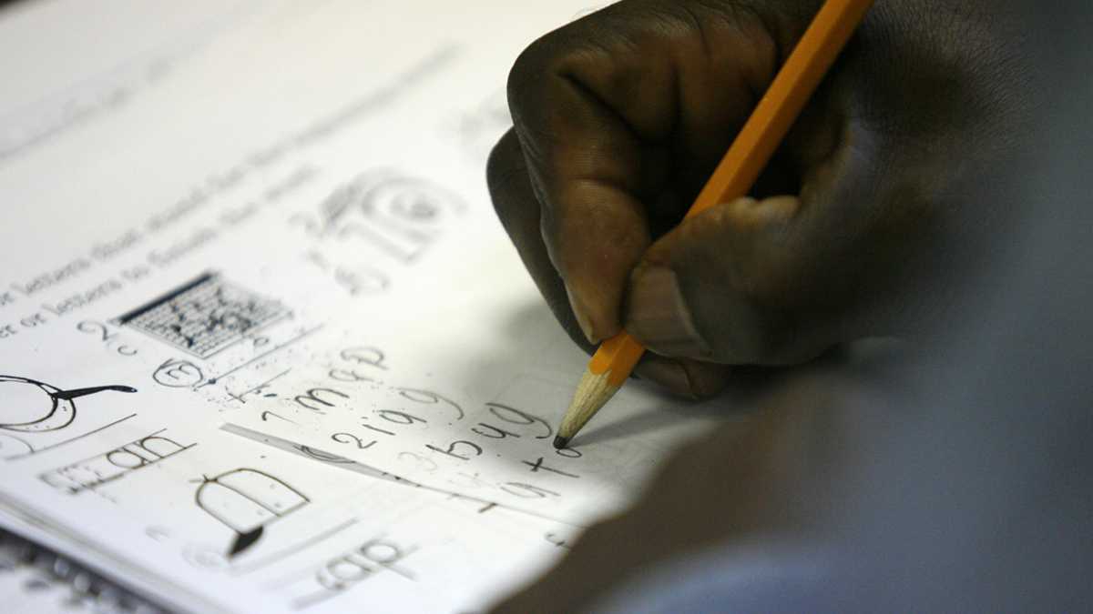  In this file image, an older student refugee from Tanzania completes a spelling exercise. (AP File Photo/Ed Zurga) 