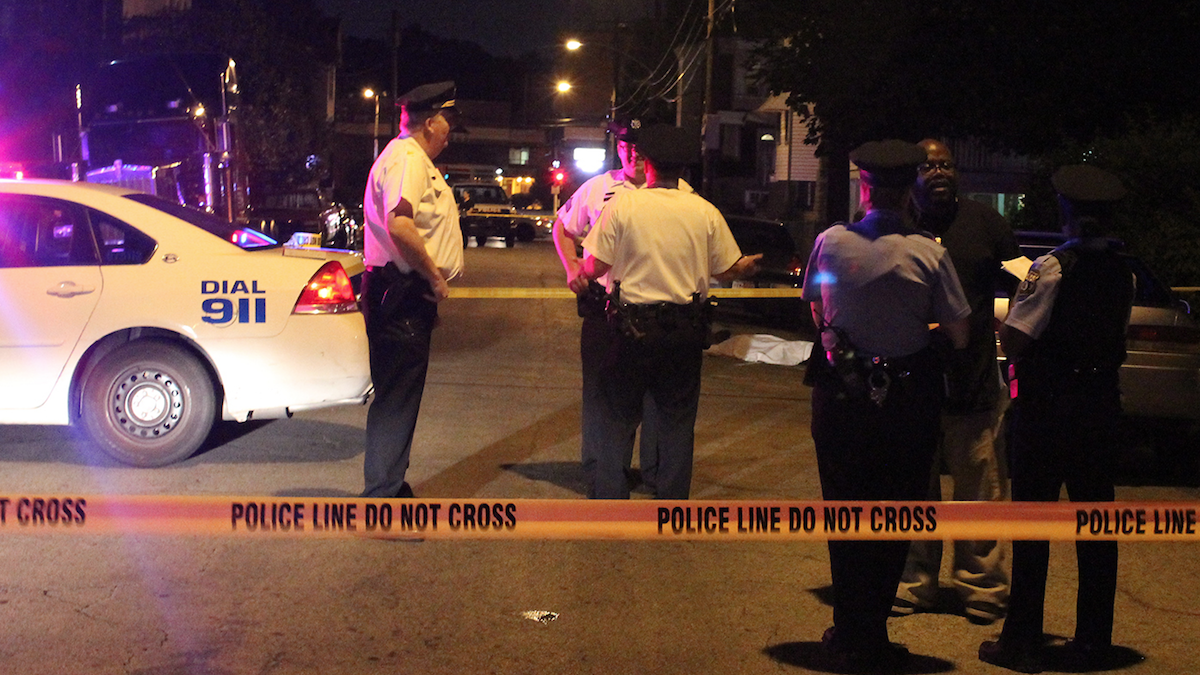  Police on the scene of the shooting on East Walnut Lane. (Matthew Grady/for NewsWorks) 