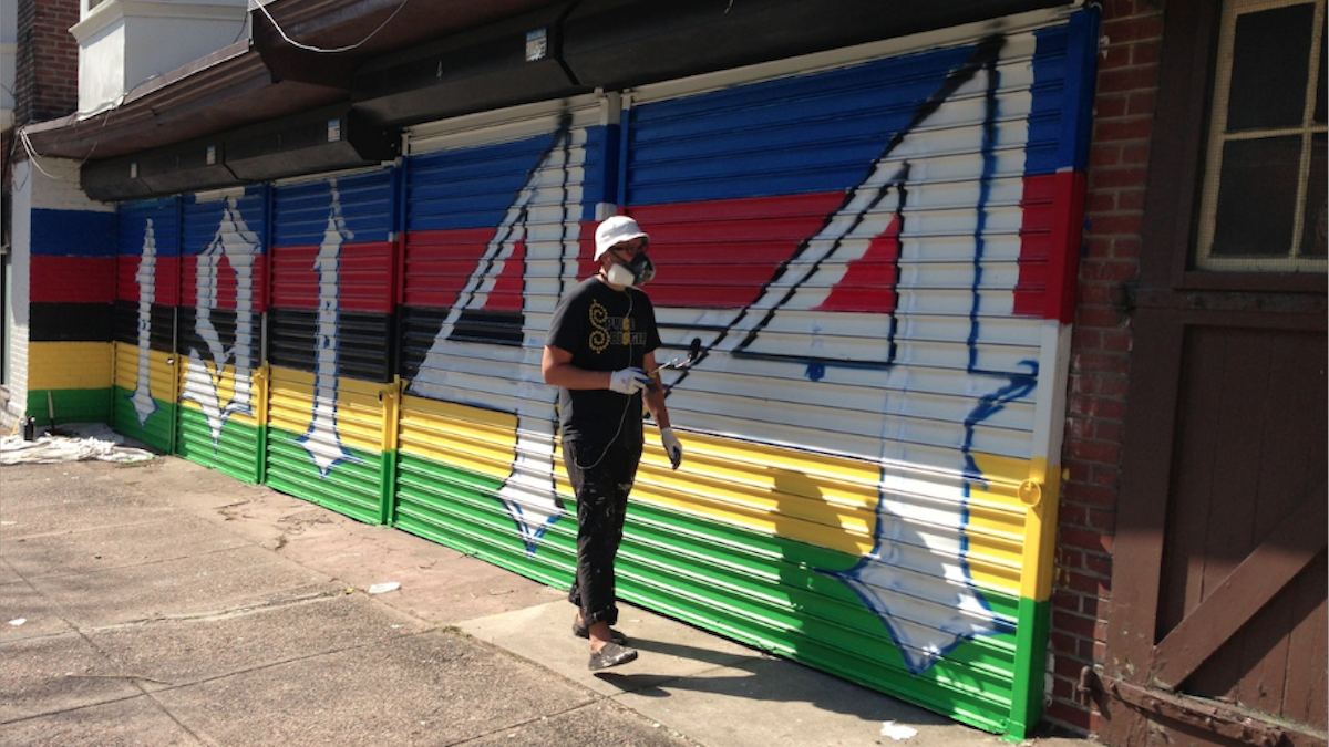  This summer, Tim Walkiewicz painted the exterior of the proposed espresso bar on West Coulter Street. (Brian Hickey/WHYY) 