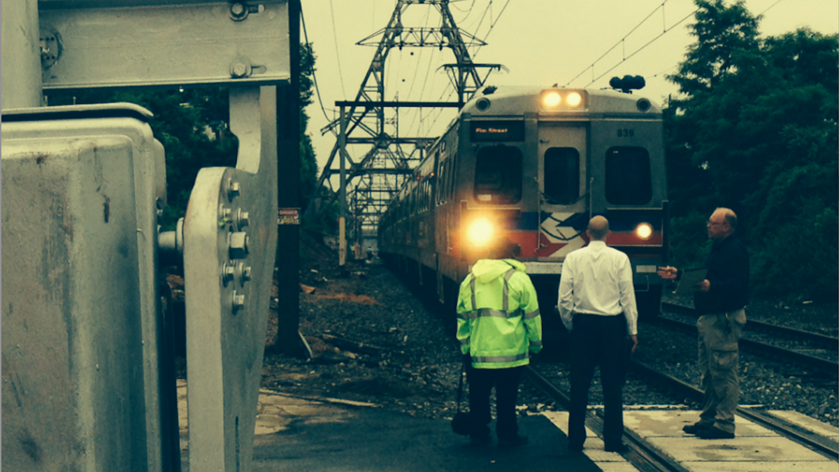 Investigators at the scene of Monday morning's suicide-by-train in East Falls. (Brian Hickey/WHYY) 