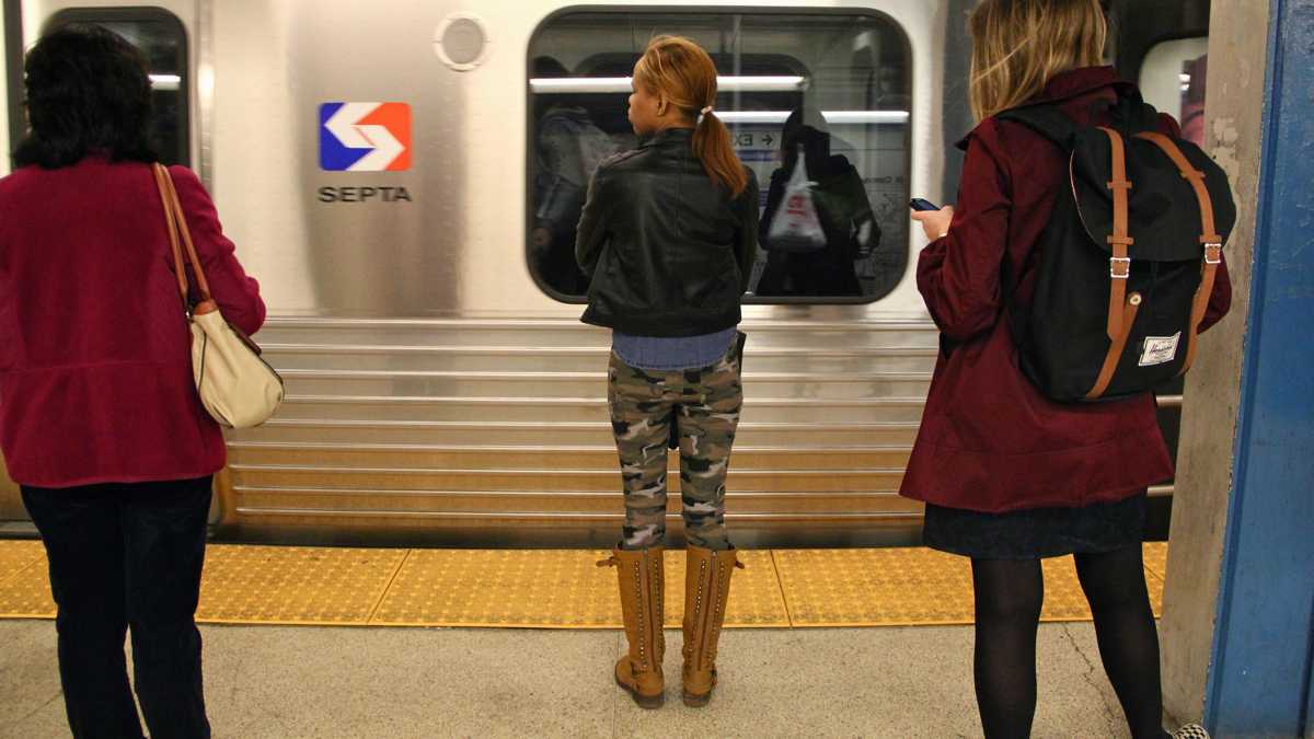  Commuters wait on a platform to board a SEPTA train. (NewsWorks file photo) 