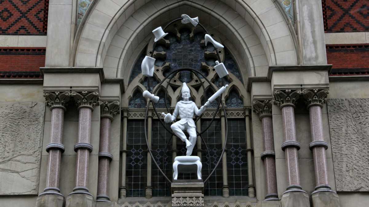  'Young Punch Juggling' by Connecticut-based artist Robert Taplin is the second in an ongoing series of temporary sculptures erected onto the façade of PAFA's historic building on North Broad Street. (Emma Lee/WHYY) 