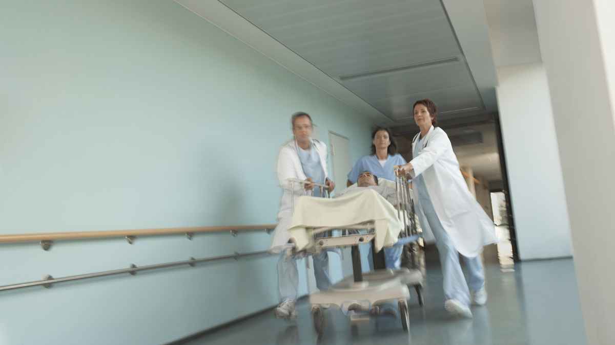  Hospital workers move a patient to surgery. (Image courtesy of <a href='http://www.shutterstock.com/pic.mhtml?id=145175149&src=p-146811386-2'>ShutterStock.com</a>) 