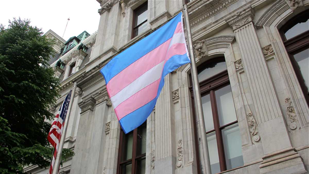 A flag representing transgender pride is shown flying at Philadelphia City Hall