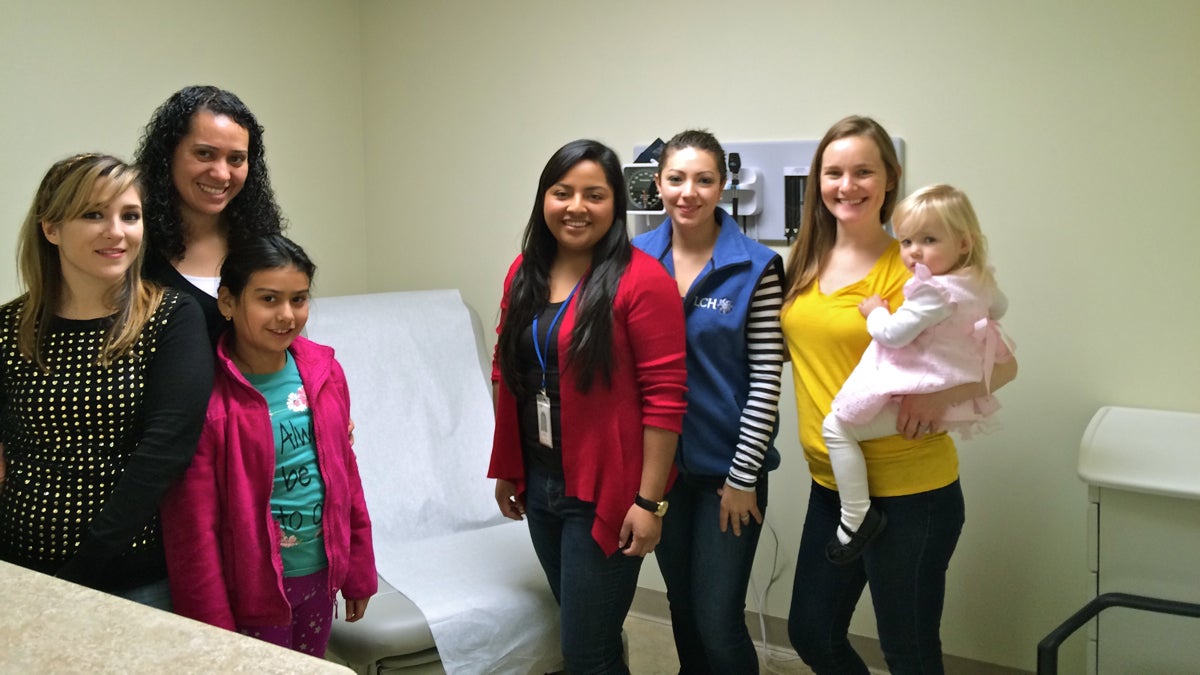  La Comunidad Hispana is opening a new health center in Oxford to serve growing numbers of Spanish speakers and low-income clients. Staff members (from left) member relations specialist Liliana Hernandez; front-to-end supervisor Cristina Gonzalez with her daughter, Shayla Nava; registered nurse Anel Medina; system application specialist/lead medical assistant Jeinny Garcia; and director of business operations and programs Amy Lambert with her daughter, Caroline, pose in one of the new exam rooms. (Photo courtesy of La Comunidad Hispana) 