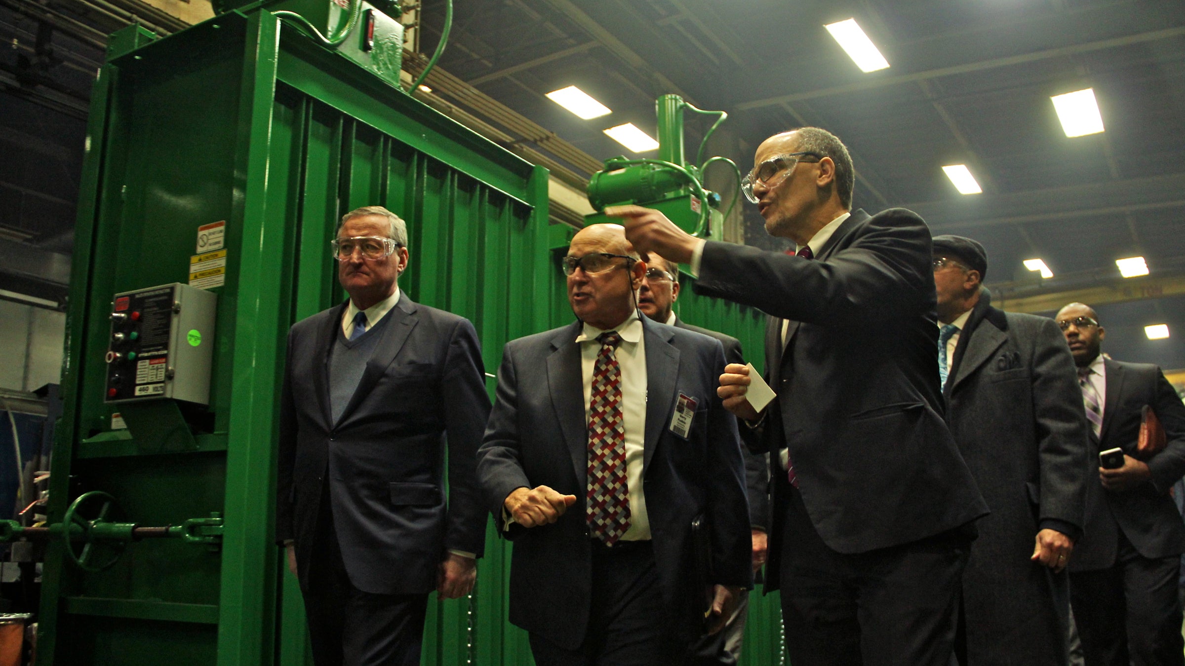  U.S. Secretary of Labor Thomas E. Perez (center) tours  PTR Baler & Compactor in Port Richmond with Philadelphia Mayor Jim Kenney (left) and other dignitaries. (Emma Lee/WHYY) 