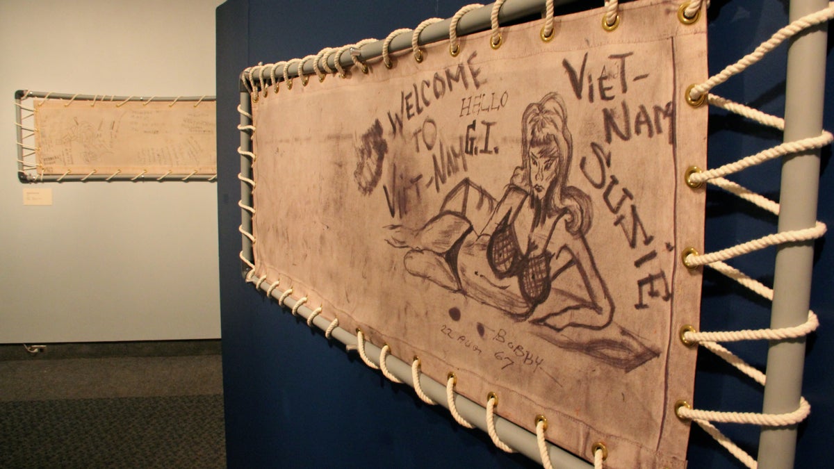 Soldiers traveling to Vietnam aboard crowded troop ships doodled on their canvas bunks, now on display at the Independence Seaport Museum. (Emma Lee/WHYY)