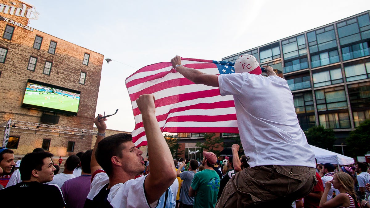  Fans hold up a flag and chant 'USA! USA!' as the final minutes ticked off of the clock in Team USA's first game in he 2014 World Cup. (Brad Larrison/for NewsWorks) 