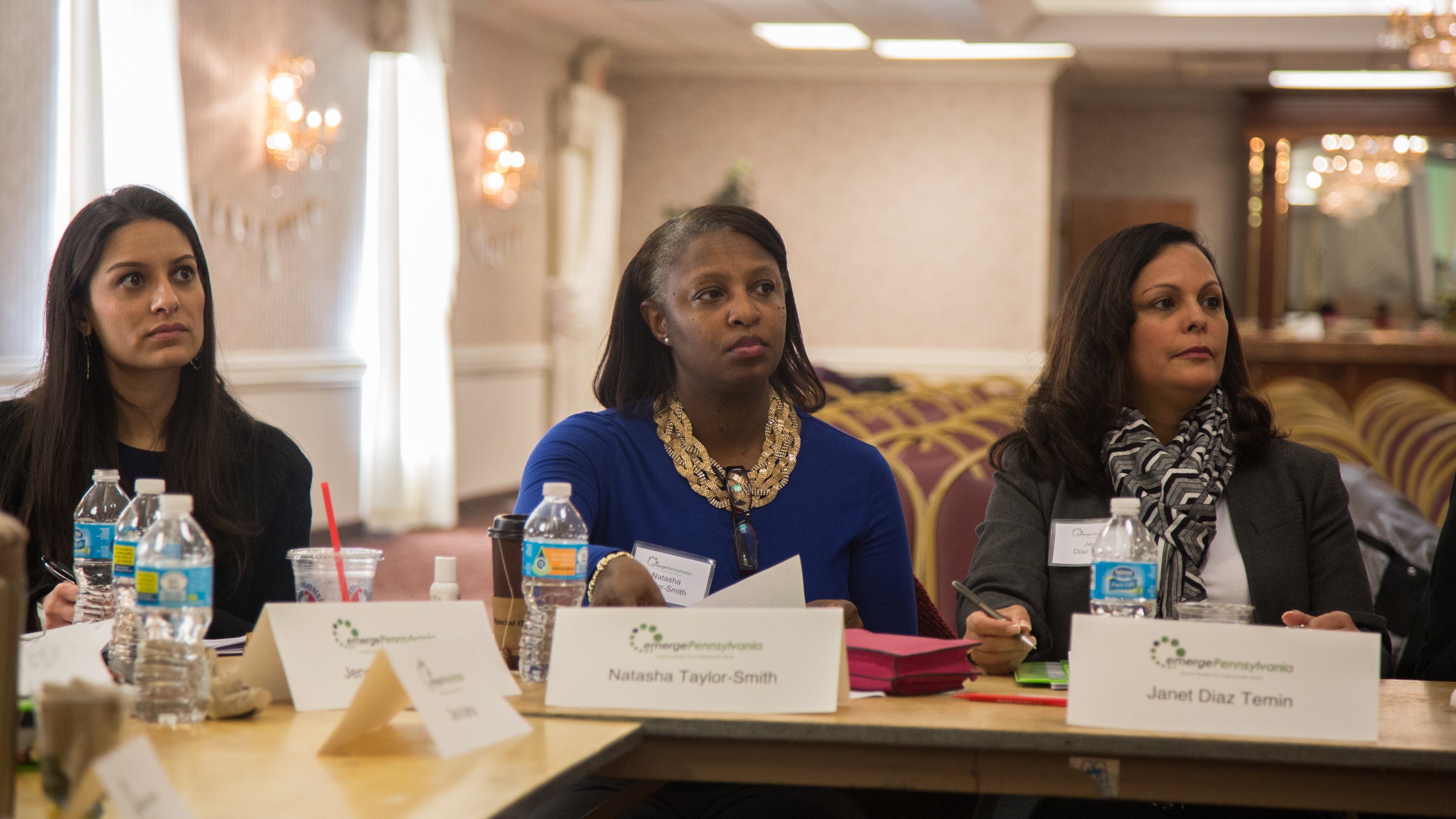 Natasha Taylor-Smith from Montgomery County (center) listens to Anne Wakabayashi, the executive director of EmergePA.  EmergePA is a democratic organization designed to prepare women who want to run for public office. (Emily Cohen for NewsWorks)