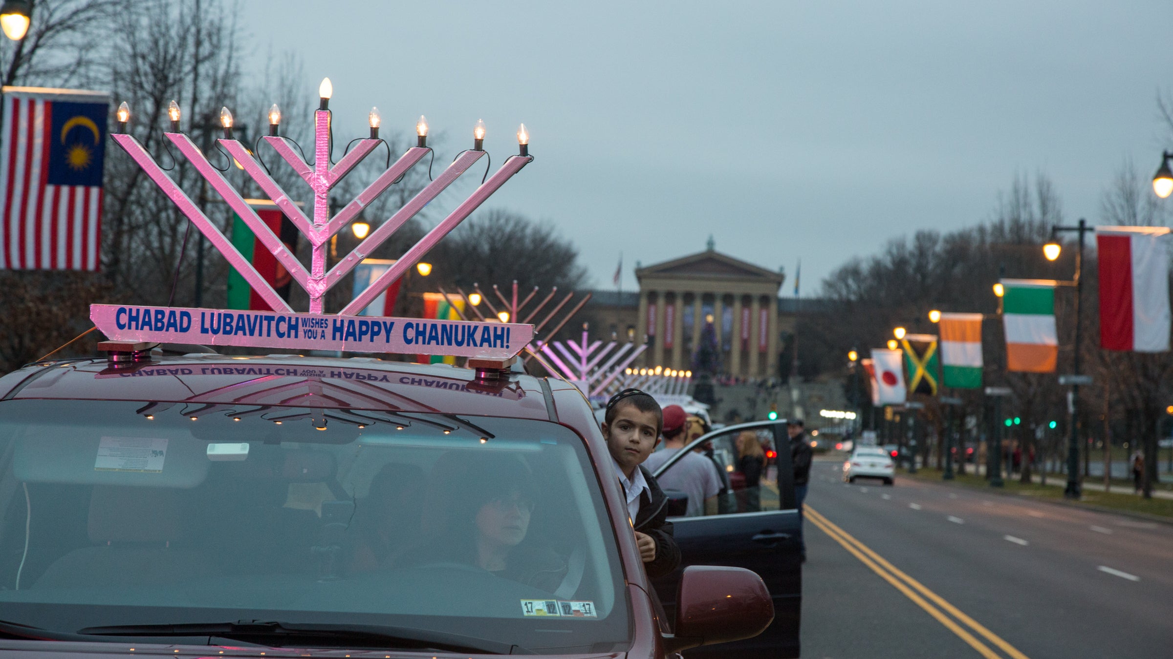More than 250 cars gather on the Ben Franklin Parkway to parade through the city with lit electric menorahs atop their roofs in celebration of the third night of Hanukkah(Emily Cohen for NewsWorks)