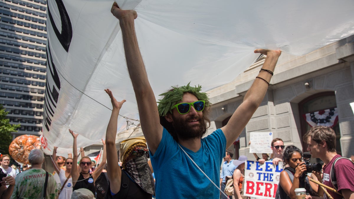 At least 20 people are needed to hold up each of the three 51-foot inflatable joints at the JayWalk, a march in support of the legalization of marijuana. The marchers were joined by others on their way to the Democratic National Convention at the Wells Fargo Center in Philadelphia July 25, 2016.  (Emily Cohen for NewsWorks)
