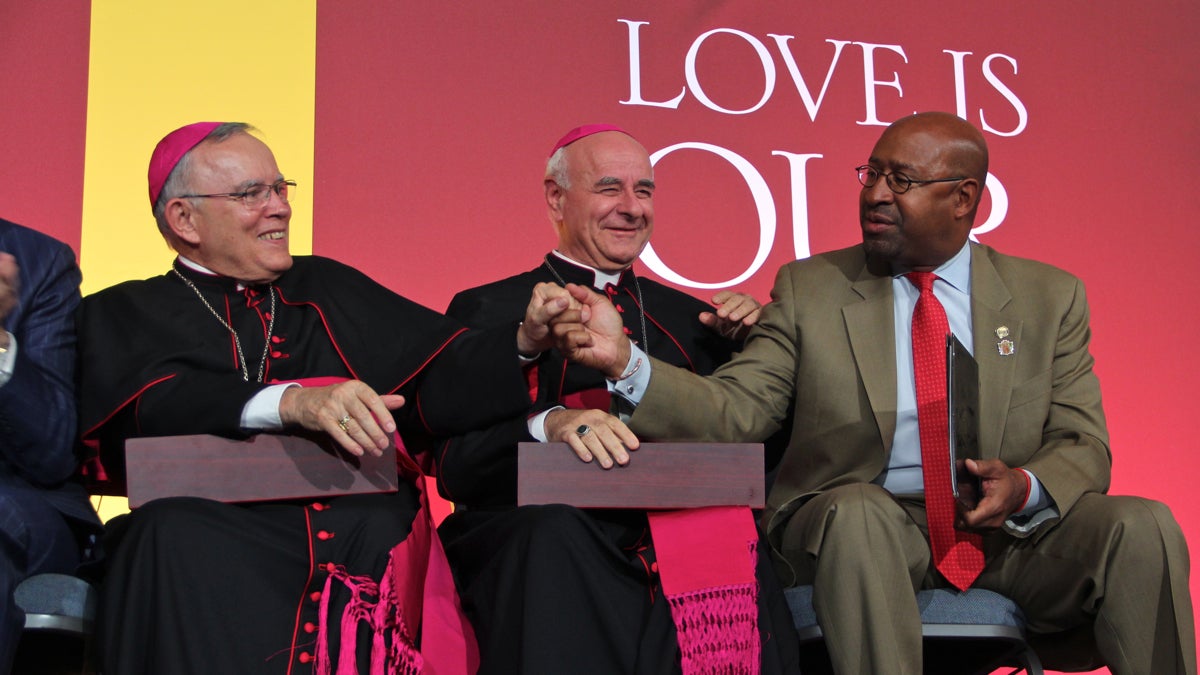 At the World Meeting of Families opening ceremony, (from left) Archbishop of Philadelphia Charles J. Chaput, 
Archbishop Vincenzo Paglia, President of the Pontifical Council for the Family, and Mayor Michael Nutter share a celebratory moment. (Emma Lee/WHYY)