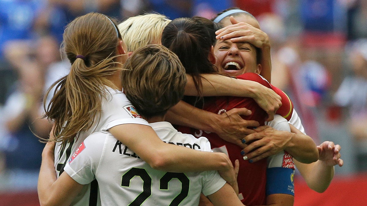 United States' Carli Lloyd, right, celebrates with teammates after Lloyd scored her third goal against Japan during the first half of the FIFA Women's World Cup soccer championship in Vancouver, British Columbia, Canada, Sunday, July 5, 2015. (AP Photo/Elaine Thompson)