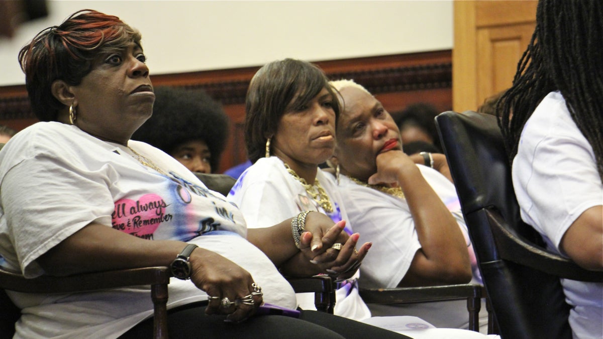 Mothers of murdered children, members of the group Mothers in Charge, comfort each other during a press conference at City Hall remembering the victims of gun violence. (Emma Lee/WHYY)
