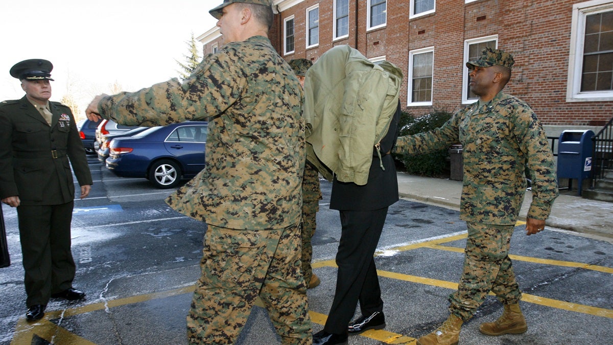  Lt. Cmdr. John Thomas Matthew Lee is seen under a jacket as he was escorted in shackles from his general court martial at Marine Corps Base Quantico Virginia in 2007. The HIV-positive Navy chaplain was then sentenced to two years in prison after pleading guilty to forcible sodomy and other charges. On Monday, Lee pleaded guilty in federal court in Delaware to production and distribution of child pornography. (AP Photo/Jacquelyn Martin) 