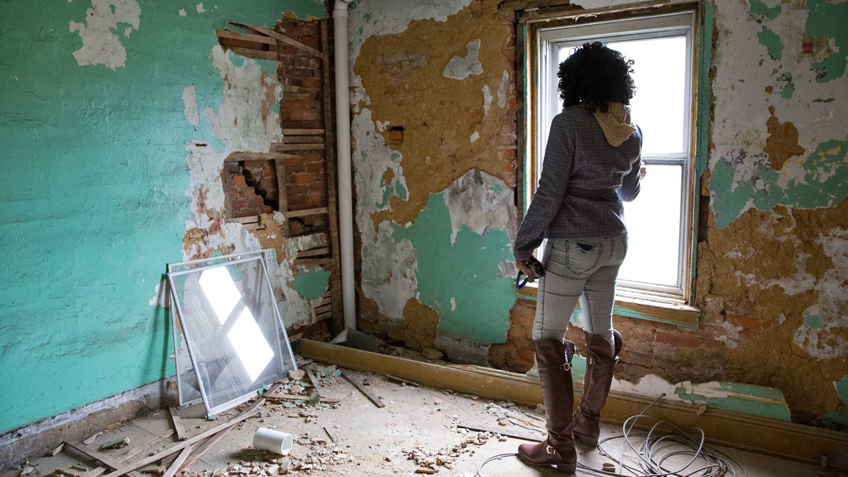  Nymiura Lee stands on the third floor of her grandparents' home in North Philadelphia. The conditions in the home became too dangerous for the family to stay.  (Lindsay Lazarski/WHYY) 