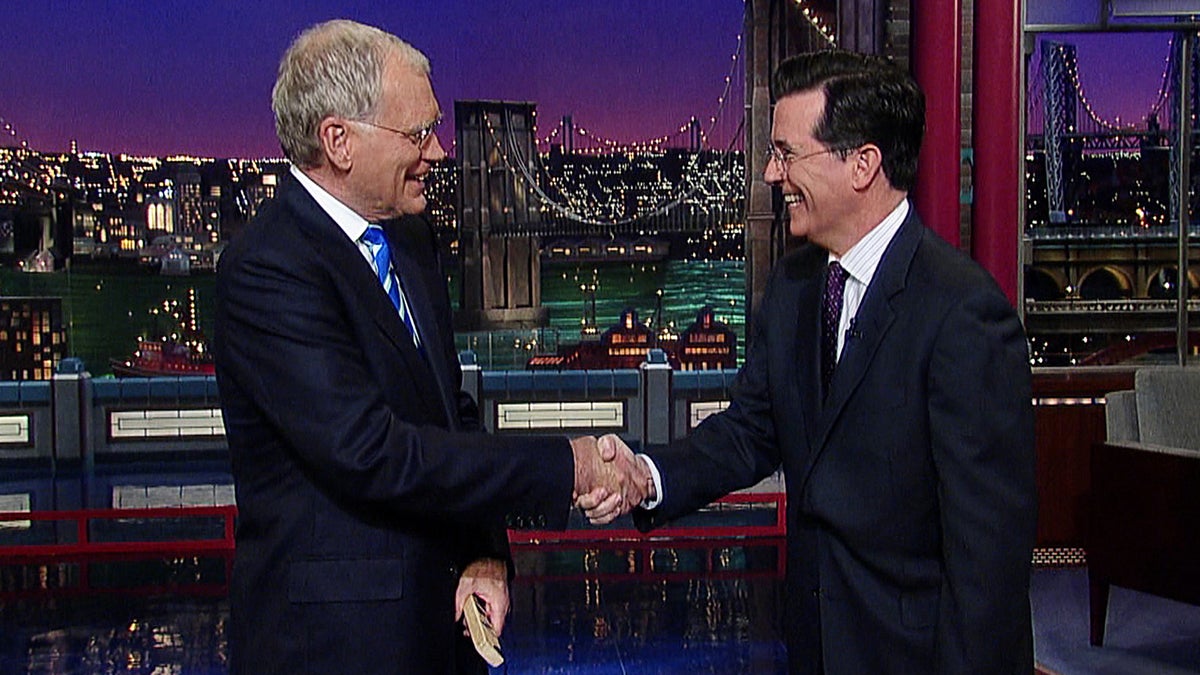  This May 4, 2011, image from video shows host David Letterman, left, shaking hands with fellow talk show host Stephen Colbert of 