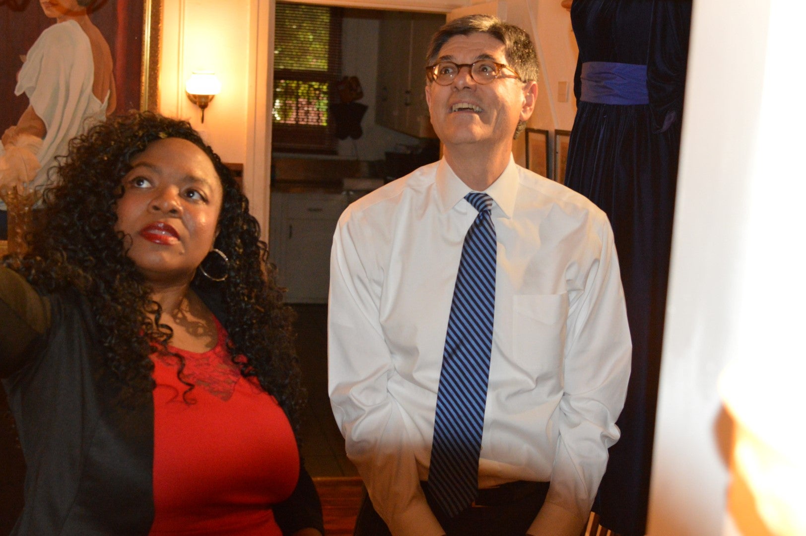 Jillian Patricia Pirtle and U.S. Treasury Secretary Jack Lew look at the dresses on display at Marian Anderson house. (Tom MacDonald/WHYY)