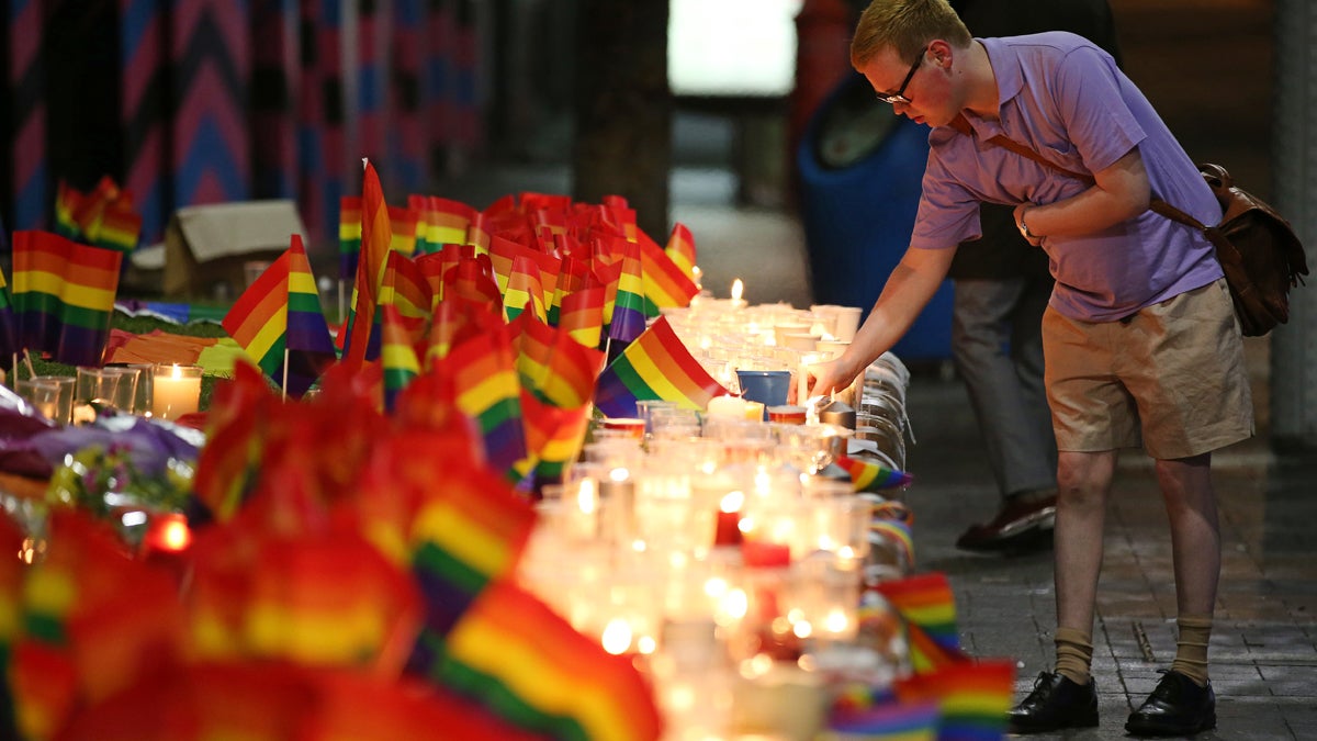 A man looks over an impromptu candle-lit memorial set up in Sydney on Monday