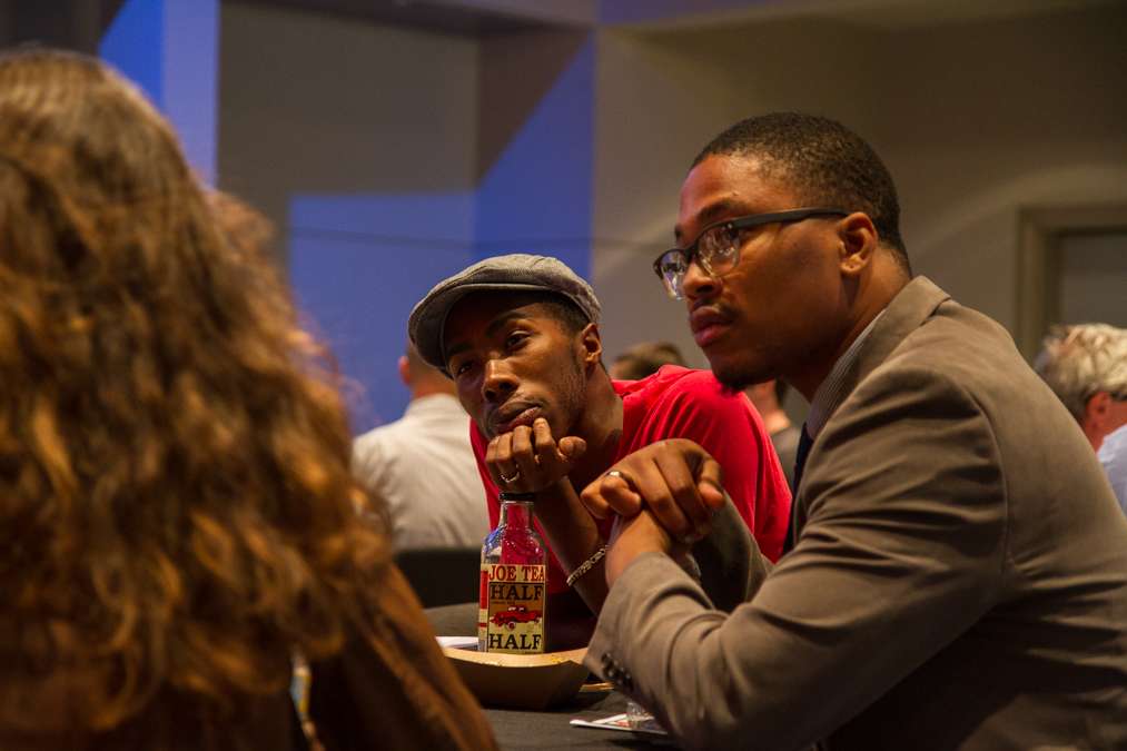 Audience members wrap up their small-group discussions before beginning the open forum.