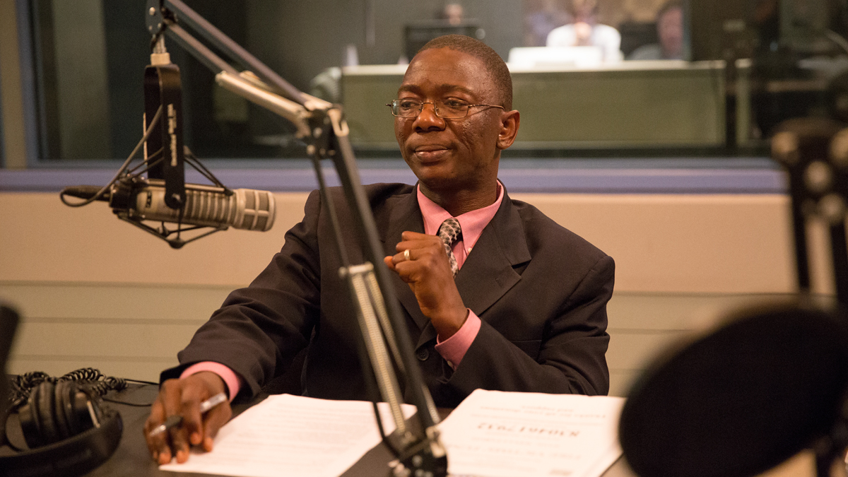  President of the Liberian Association of Pennsylvania Dahn Dennis speaks to NewsWorks Tonight host Dave Heller about the aftermath of a tragic fire that killed four children in southwest Philadelphia.  (Lindsay Lazarski/WHYY) 