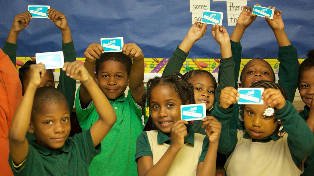  Students at James G. Blaine Elementary School show off their library cards. The Free Library of Philadelphia will distribute 98,000 cards to students throughout the district (Nathaniel Hamilton/for NewsWorks). 