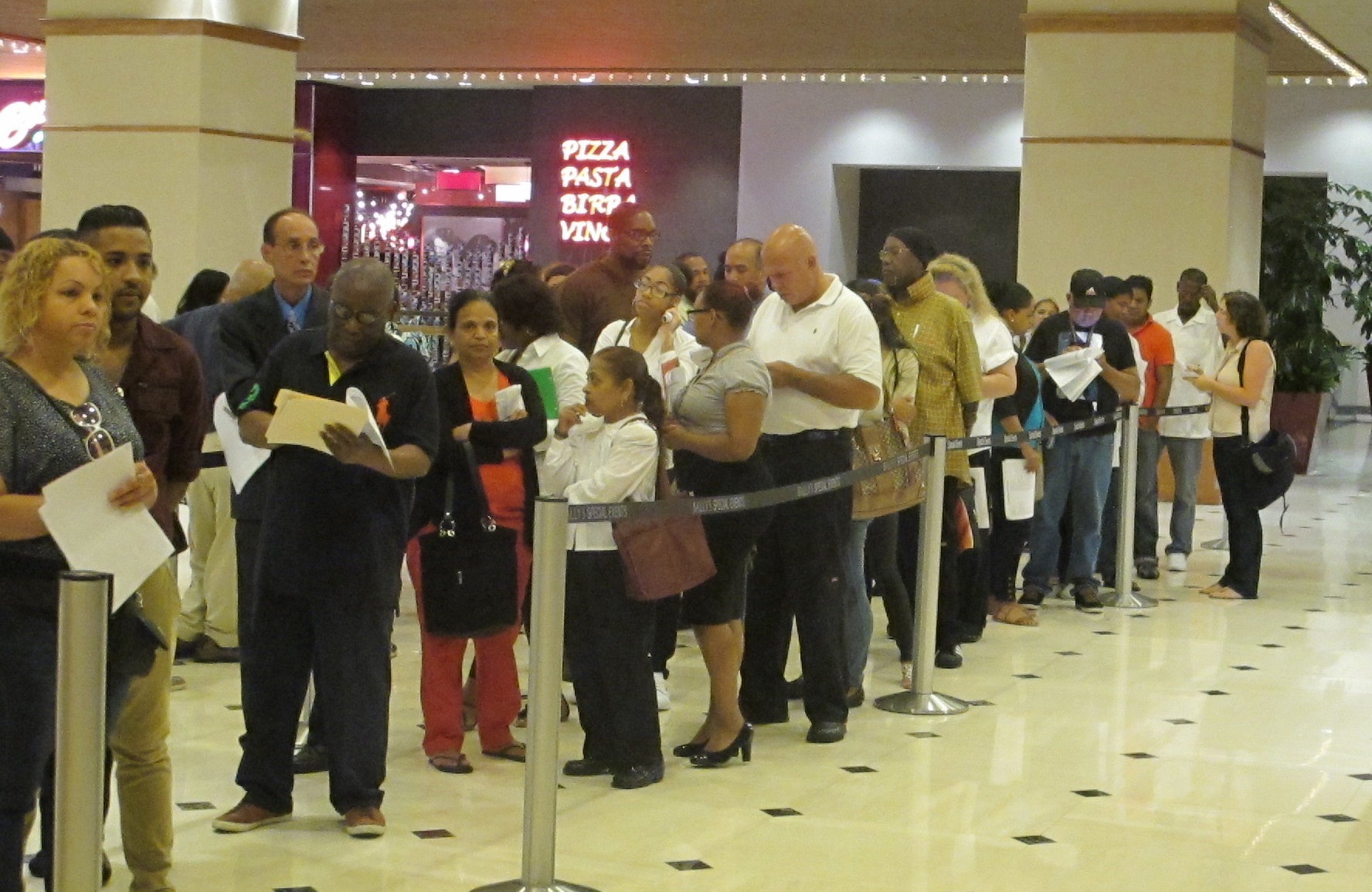 Applicants line up Wednesday at a job fair  in Atlantic City. Caesars International held the event at Bally's as it tries to fill more than 500 positions at its casinos in Atlantic City