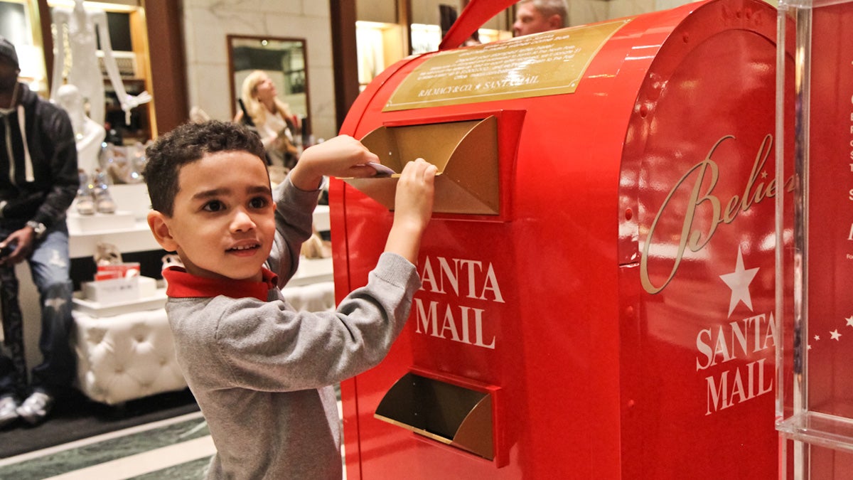 AJ Piccolo-Cooper drops his letter to Santa at Macy's in Center City Philadelphia. (Kimberly Paynter/WHYY)