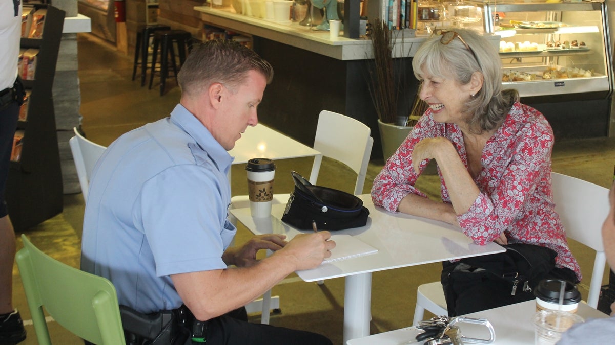  Officer Robert Mahan speaks to Chestnut Hill resident Sue Hankin during a recent 'Coffee With A Cop' event. (Matt Grady/for NewsWorks) 