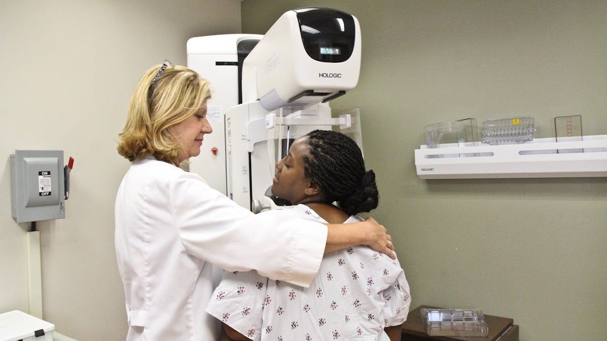 Chief Technician Donna Burke demonstrates how a mammogram is given with the help of Sharon Born
