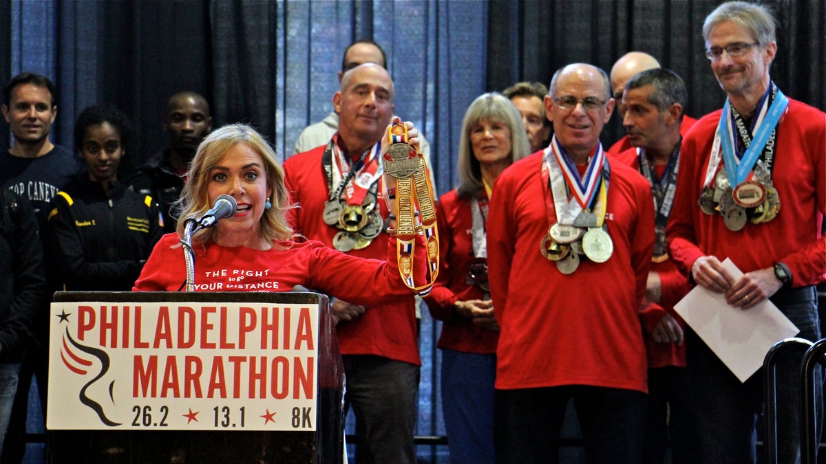 Philadelphia Marathon Executive Director Sheila Hess holds up a medal that will be awarded to finishers of the Rocky Challenge