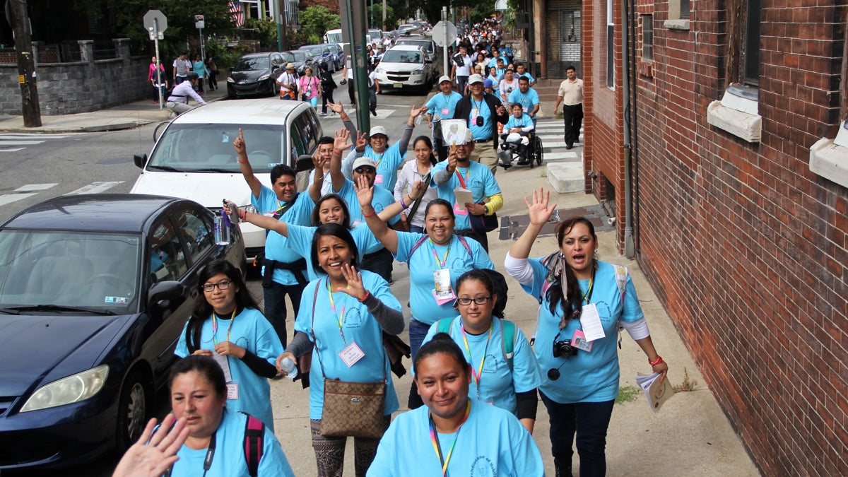 About 1,000 people march through South Philadelphia to Independence Mall to hear Pope Francis speak. (Emma Lee/WHYY)