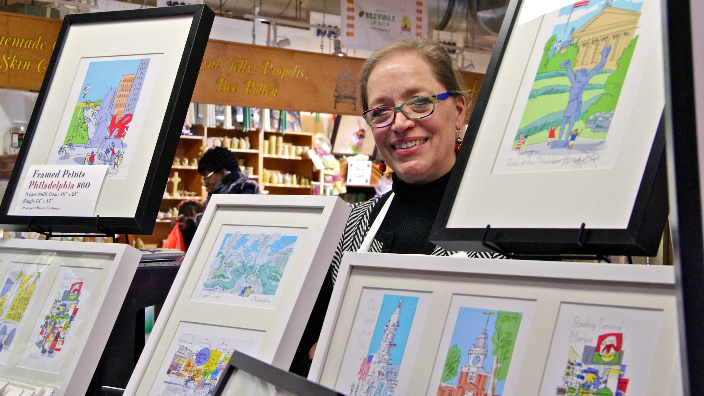  Marilyn MacGregor sells her prints from a wagon in Reading Terminal Market. (Emma Lee/WHYY) 