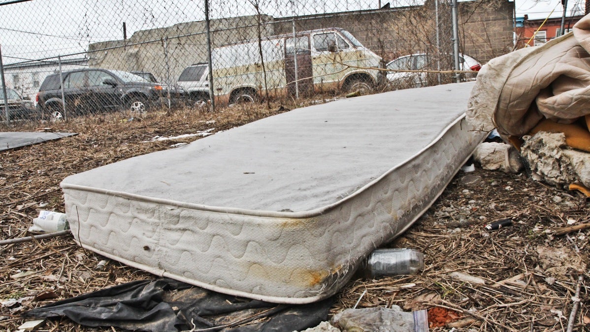  A mattress sits  among litter in a South Philadelphia lot. (Kimberly Paynter/WHYY) 