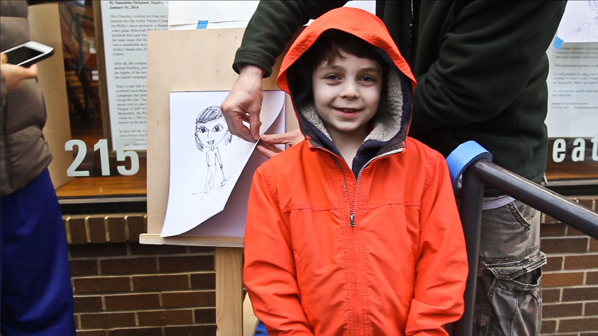  Max Perlman, 8, spends first Fridays drawing dollar portraits of art lovers outside the Arden Theater in Old City, Philadelphia. (Kimberly Paynter/WHYY) 