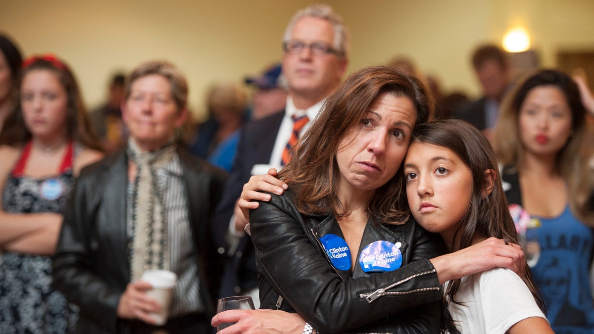 Heather Silvestri embraces her daughter Zoe Ferguson as they watch the disappointing election returns. (Jonathan Wilson for Newsworks)