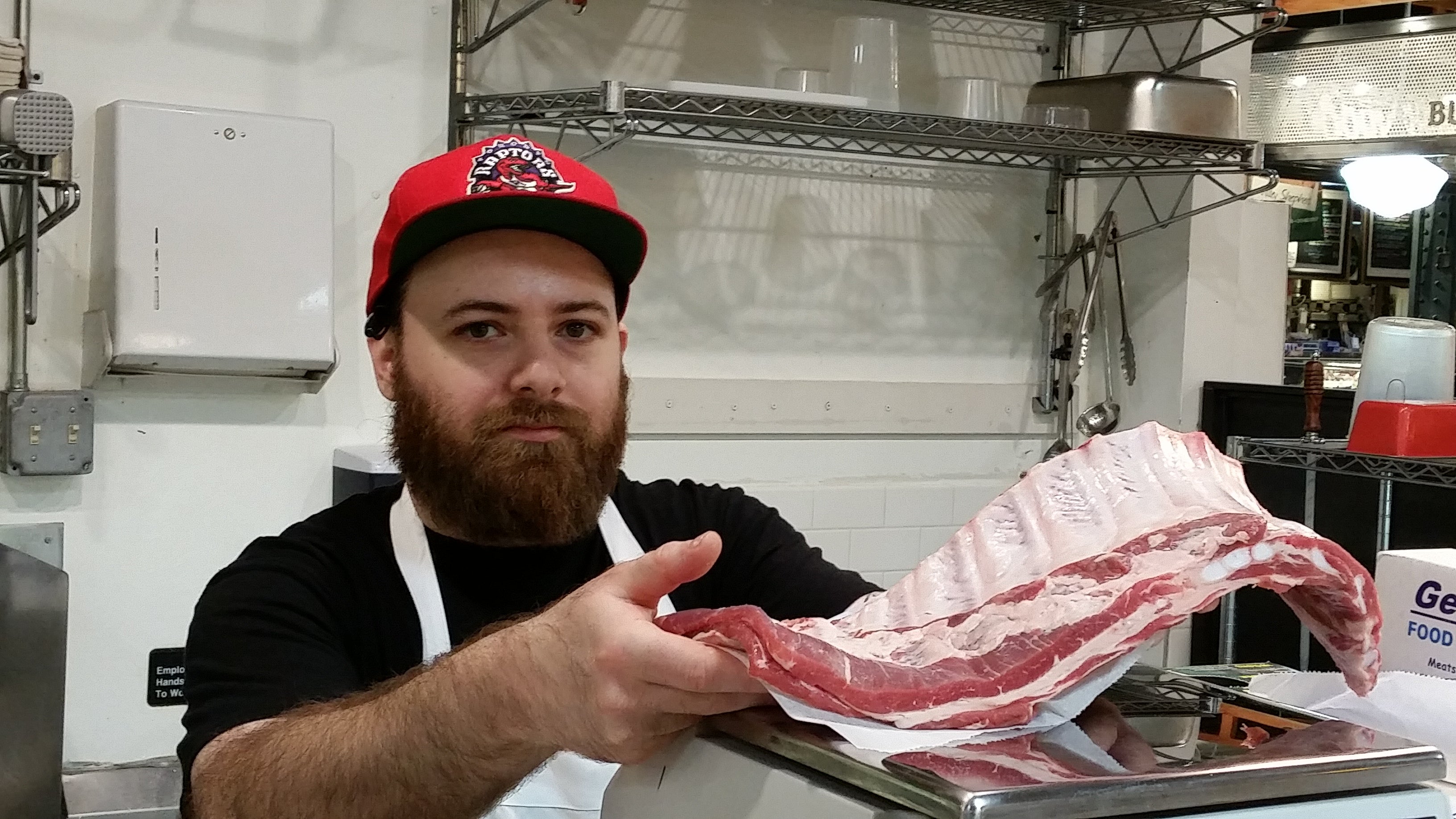  Butcher Nick Macri shows off ribs at Reading Terminal Market. (Tom MacDonald/WHYY) 