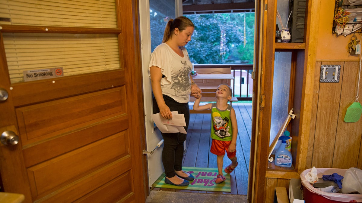  Michelle Andrews helps her son, Gabriel, into the house after playing in the backyard. She is one of three women Keystone Crossroads' reporter Marielle Segarra followed for the story, “At Allentown’s Turner Street program, insight into what homeless families need.” Listen here: http://bit.ly/2dRsU4A (Lindsay Lazarski/WHYY) 