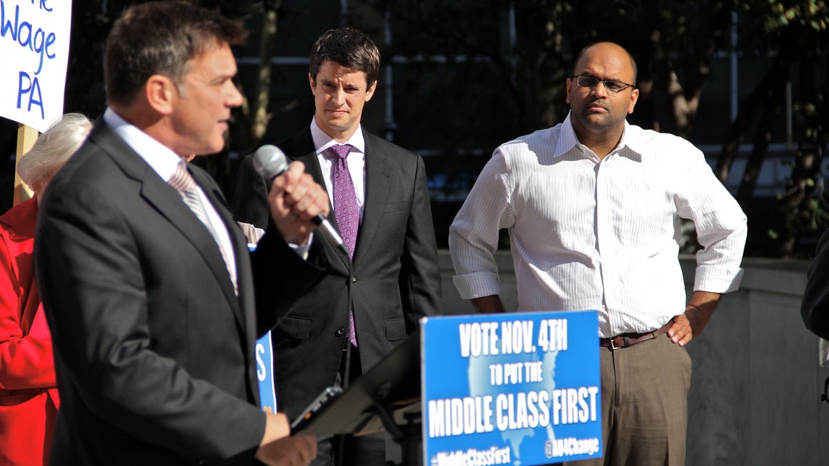 Democratic congressional candidates Manan Trivedi (right) and Kevin Strouse (center) attend a rally in LOVE Park. (Emma Lee/WHYY)