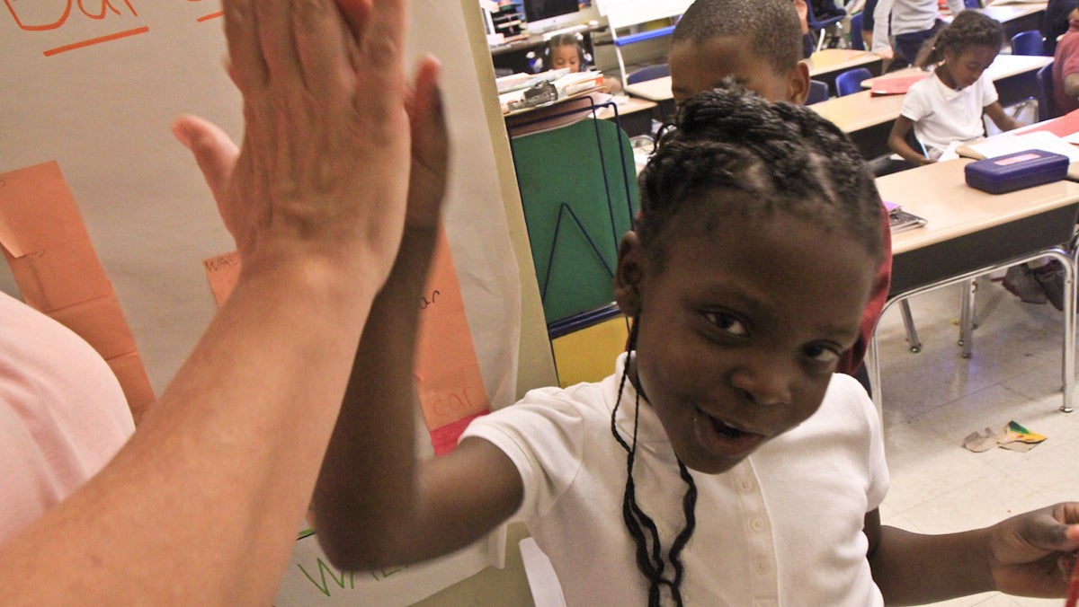  Mifflin Principal Leslie Mason delivers a high five to first-grader Daiyanah Gibson for learning to count. (Kimberly Paynter/WHYY) 