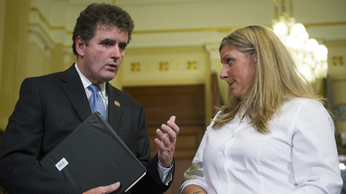  U.S. Rep. Mike Fitzpatrick, R-Pa., talks with witness Kristen Ruell, authorization quality review specialist in the Pension Management Center at the Veterans Affairs Philadelphia Regional Office, prior to her testifying to the House Committee on Veterans Affairs on Monday. (Cliff Owen/AP photo) 